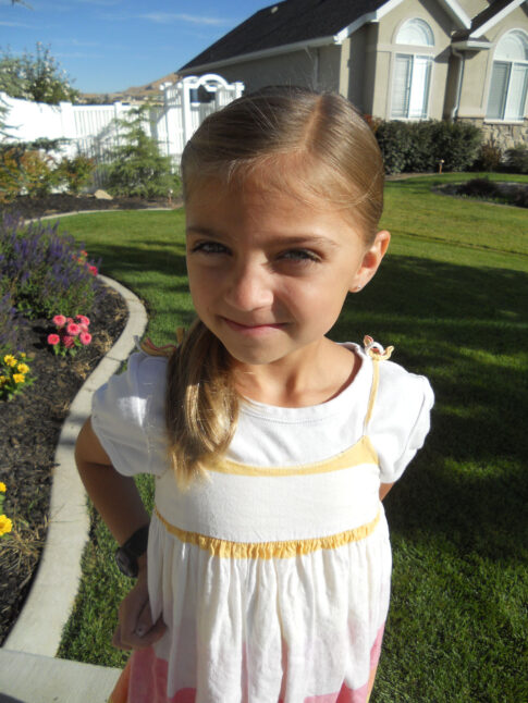 Portrait of young girl modeling the Twistback Flip Under