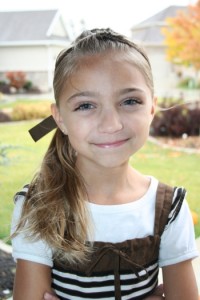 Portrait of young girl modeling Tween Knots Ponytail