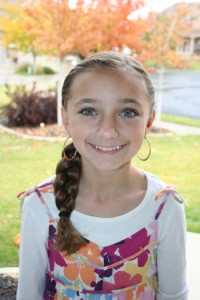 Portrait of young girl modeling the Double-Twist into Side Braid