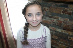 Portrait of young girl modeling the Reverse French Headband into a Rose 