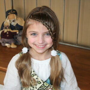 Portrait of young girl modeling the Lace Braid into Soft Ponytails