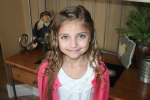 Portrait view of young girl modeling the Waterfall Braid Hairstyle with Spiral Curls 