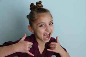 Portrait view of young girl modeling The Bun Hawk | Crazy Hair Day Hairstyles