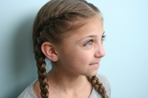 Portrait view of young girl modeling the Primrose Everdeen Braids | Hunger Games Hairstyles