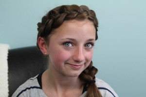 Portrait view of young girl modeling the Wrap-Around Dutch Pancake Braid | Braid Hairstyles
