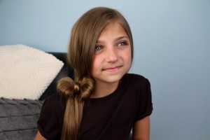 Portrait view of a young girl modeling the Side Ponytail Hair Bow | Cute Hairstyles