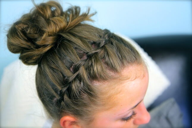 Top side view of Waterfall Braided Headband into a Messy Bun.