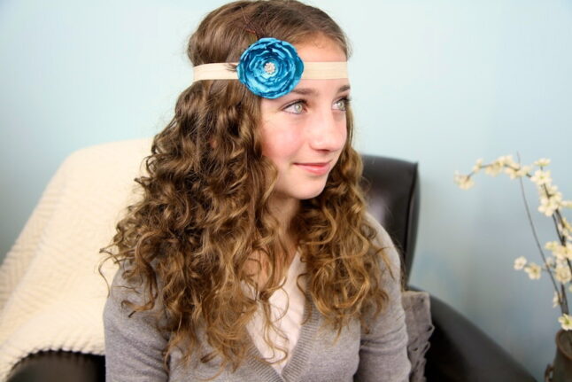 Portrait of young girl with curling hair posing