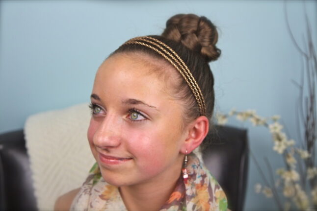 Portrait of a young girl modeling the Simple Braided Bun Hairstyle