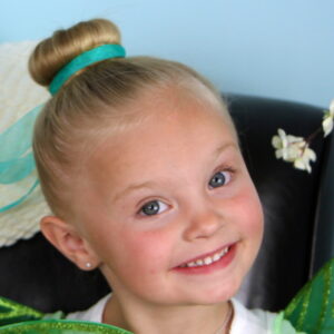 Portrait of a little girl modeling Tinker Bell Hair Bun | Disney Hairstyles