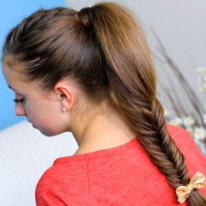 Back view of young girl wearing a red shirt modeling Fluffy Fishtail Braid | Hairstyles for Long Hair