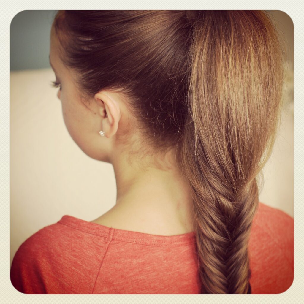 Back view of young girl wearing a red shirt modeling Fluffy Fishtail Braid | Hairstyles for Long Hair