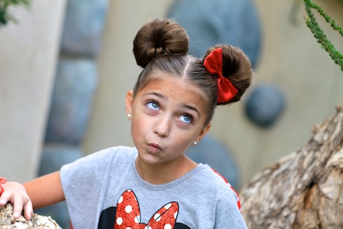 Portrait of a young girl outside modeling Minnie Mouse Buns | Hairstyle Tutorial