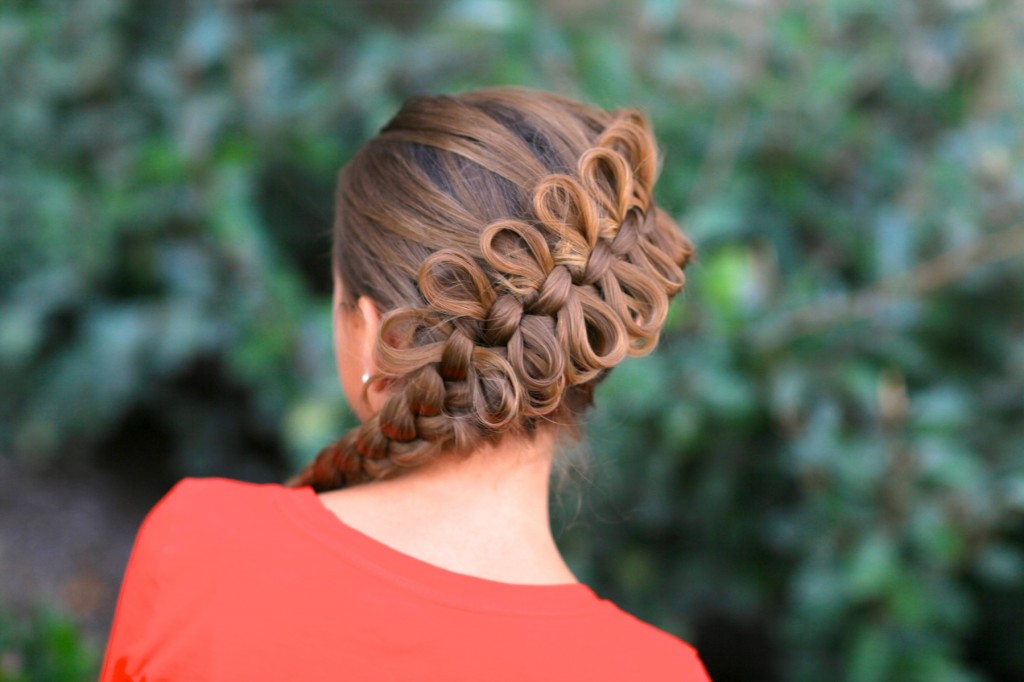 (Back) Young girl wearing a red shirt outside modeling Diagonal Bow Braid | Popular Hairstyles