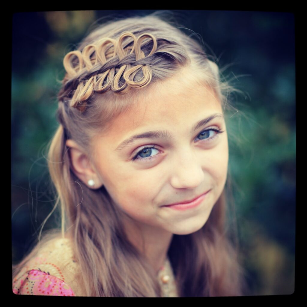 Portrait of young girl outside modeling Prim Bow Braid Tieback | Catching Fire | The Hunger Games