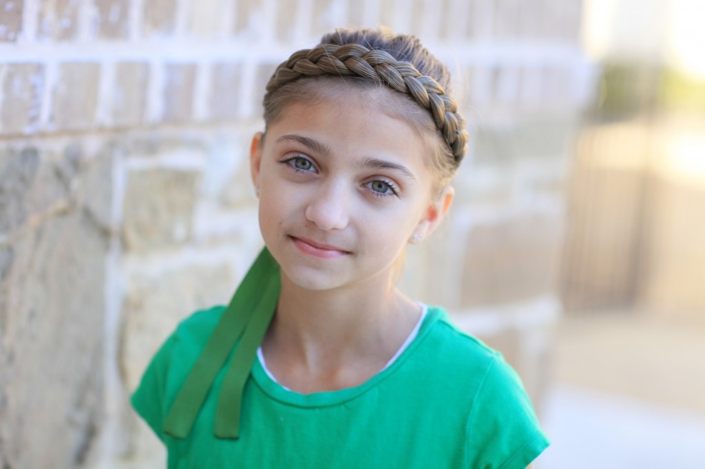 Portrait of young girl modeling Disney Frozen inspired Anna's Coronation Hairstyle 