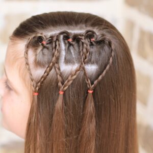 Young girl outside modeling Triple Braided Heart | Valentine's Day Hairstyles