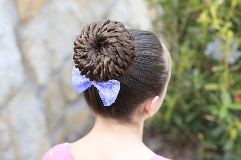 Young girl standing outside modeling Rope Twisted Pinwheel Bun | Prom Hairstyles