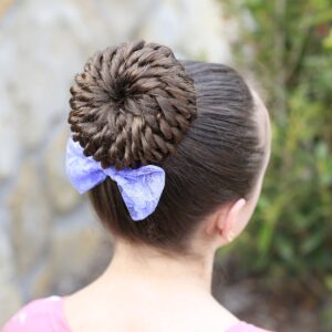 Young girl standing outside modeling Rope Twisted Pinwheel Bun | Prom Hairstyles