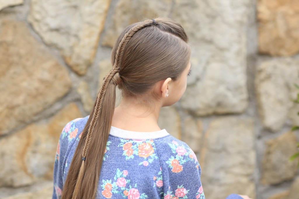 Fishtail BraidYoung girl standing outside modeling Fishtail-Accented Ponytail | Hairstyles for Sports