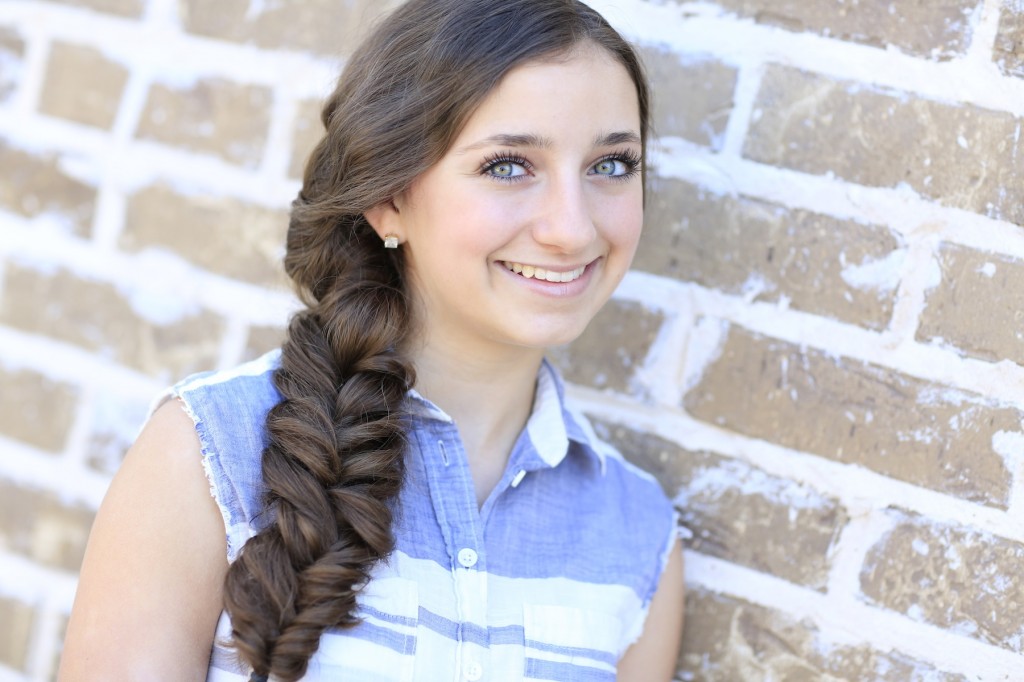 Young woman standing outside modeling Alternative Braid