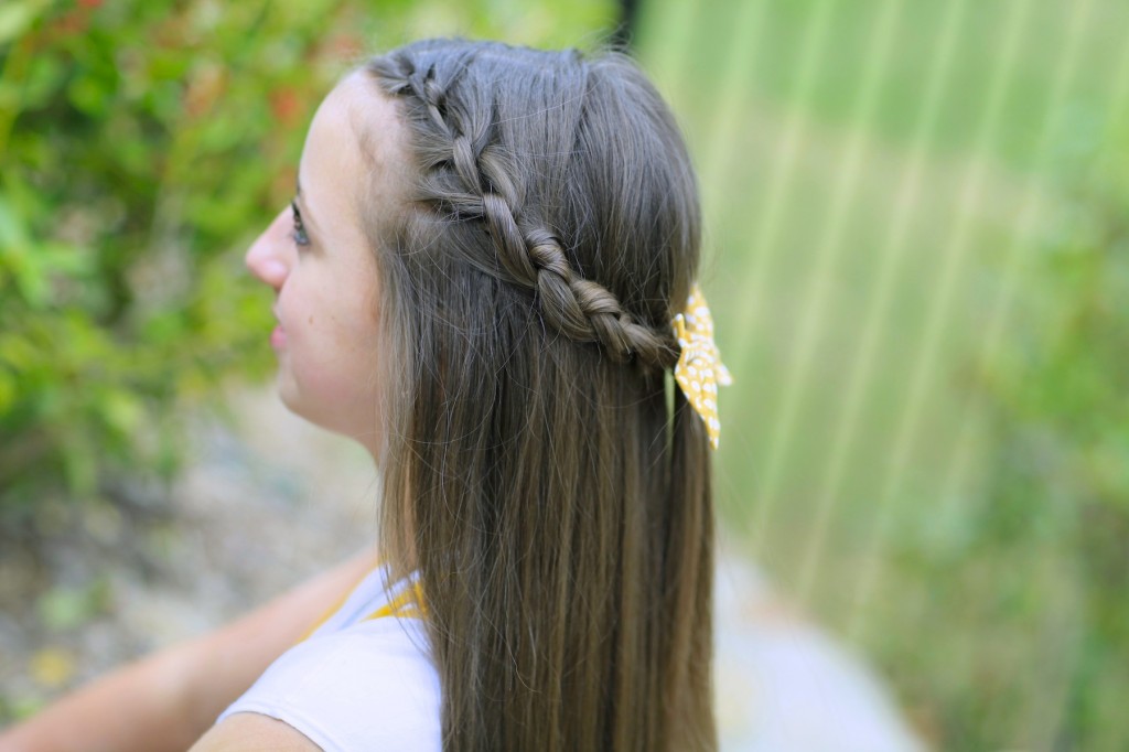 Young girl outside modeling Knotted Braid Tieback