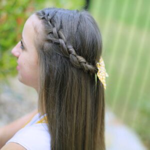 Young girl outside modeling Knotted Braid Tieback