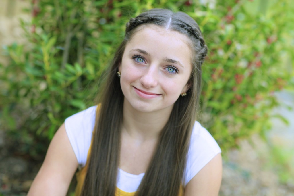 Young girl outside modeling Knotted Braid Tieback