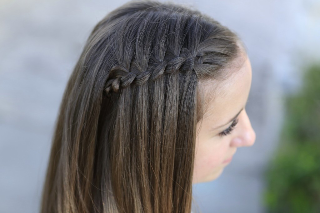 Young girl outside modeling Four-Strand Waterfall Braid