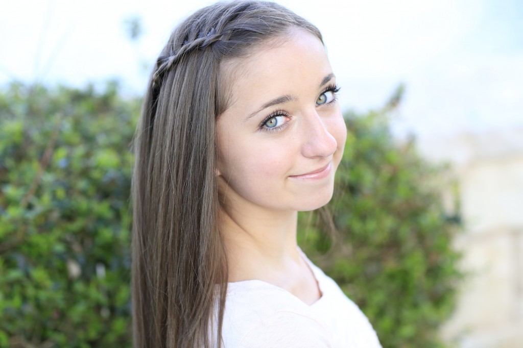 Young girl outside modeling Four-Strand Waterfall Braid