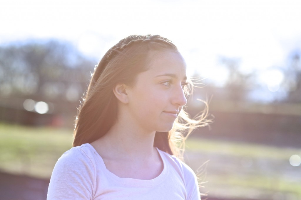 Young girl outside modeling Four-Strand Waterfall Braid