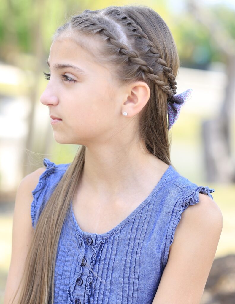 Young girl outside modeling Rope Braid Tieback Hairstyle