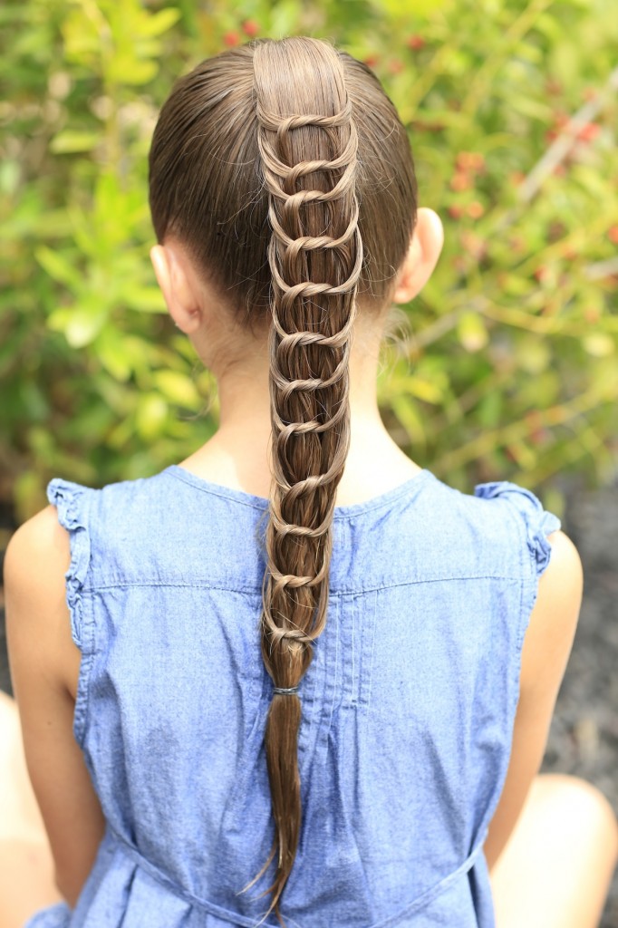 Young girl outside modeling The Knotted Ponytail | Cute Hairstyles