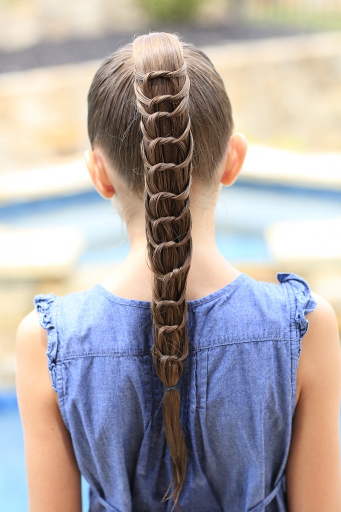 Young girl outside modeling The Knotted Ponytail | Cute Hairstyles