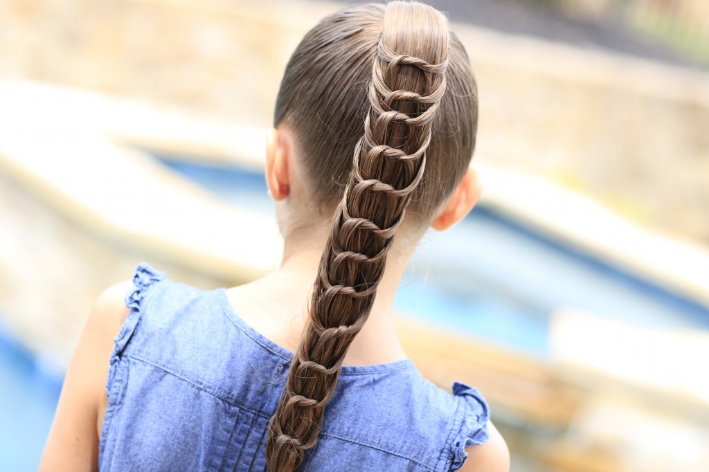 Young girl outside modeling The Knotted Ponytail | Cute Hairstyles