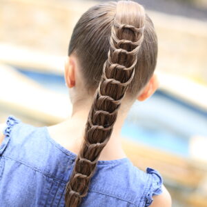 Young girl outside modeling The Knotted Ponytail | Cute Hairstyles