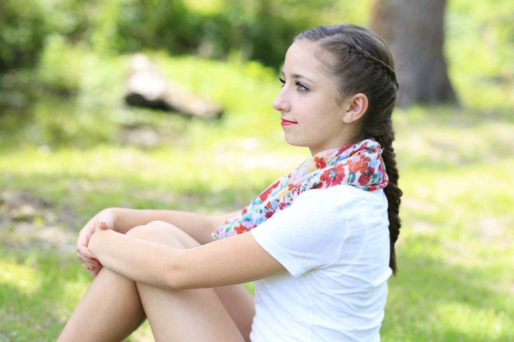 Young girl outside modeling Laced Fishtail Braid