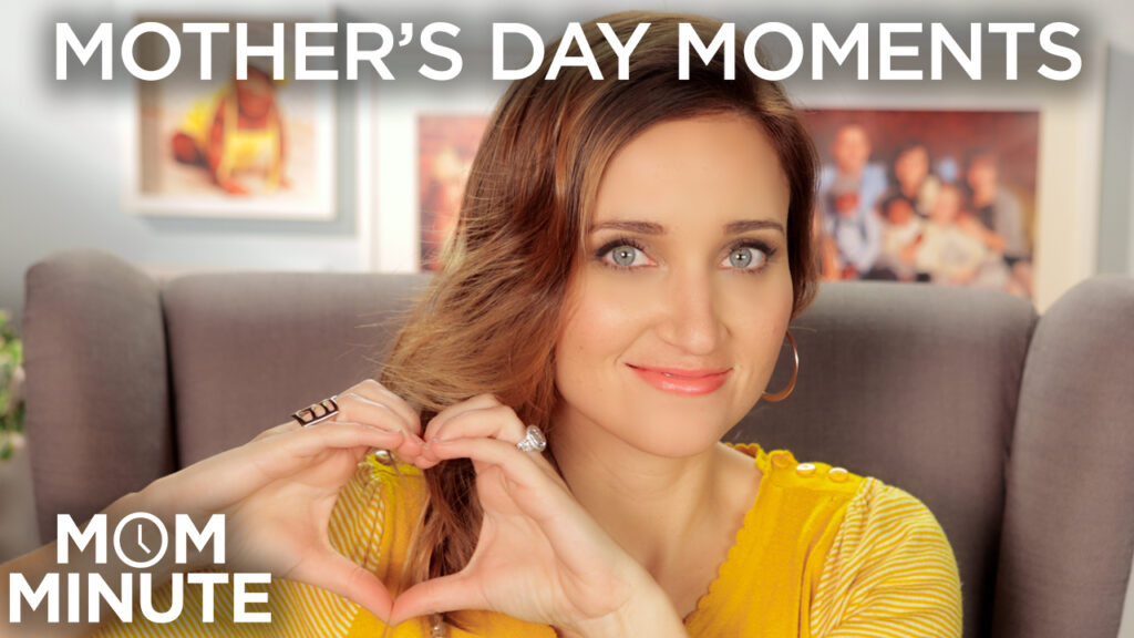 Woman posing while sitting in a chair in the living room making a heart with her palms