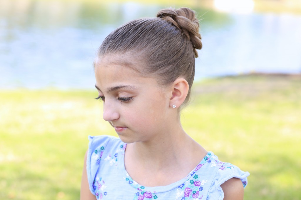 Little girl sitting outside modeling 3D Flower Bun Updo