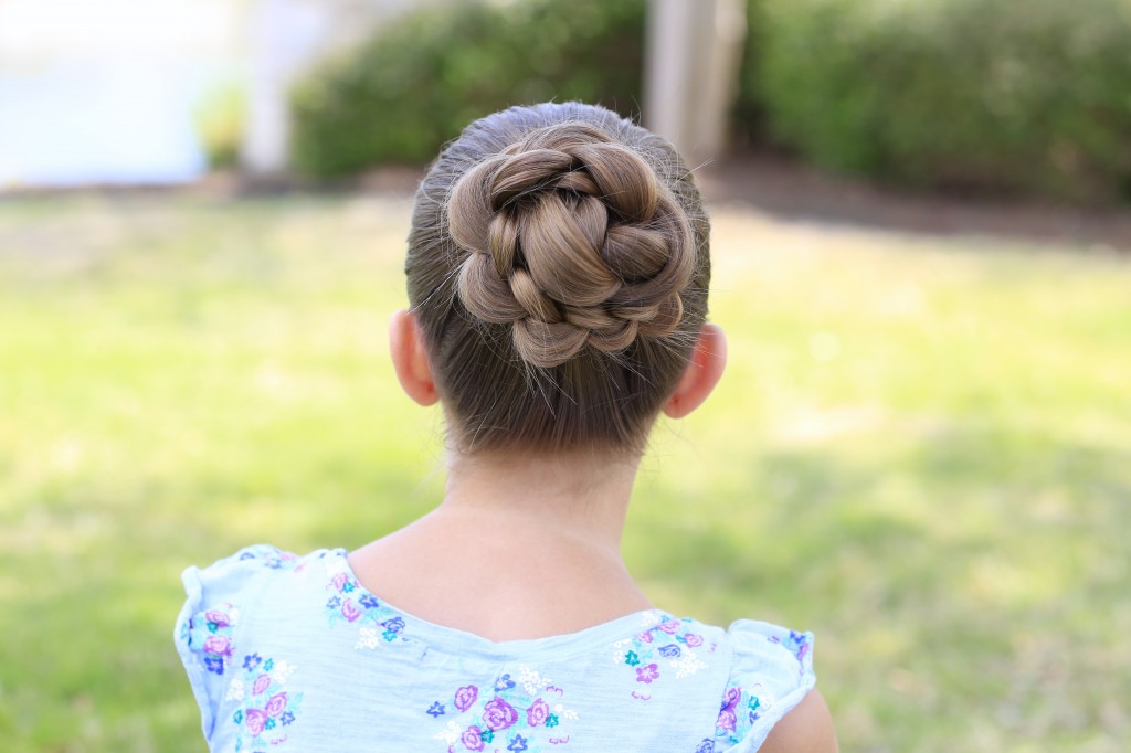 Little girl sitting outside modeling 3D Flower Bun Updo