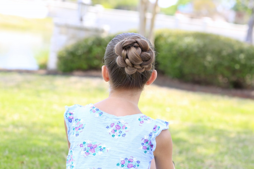 Little girl sitting outside modeling 3D Flower Bun Updo