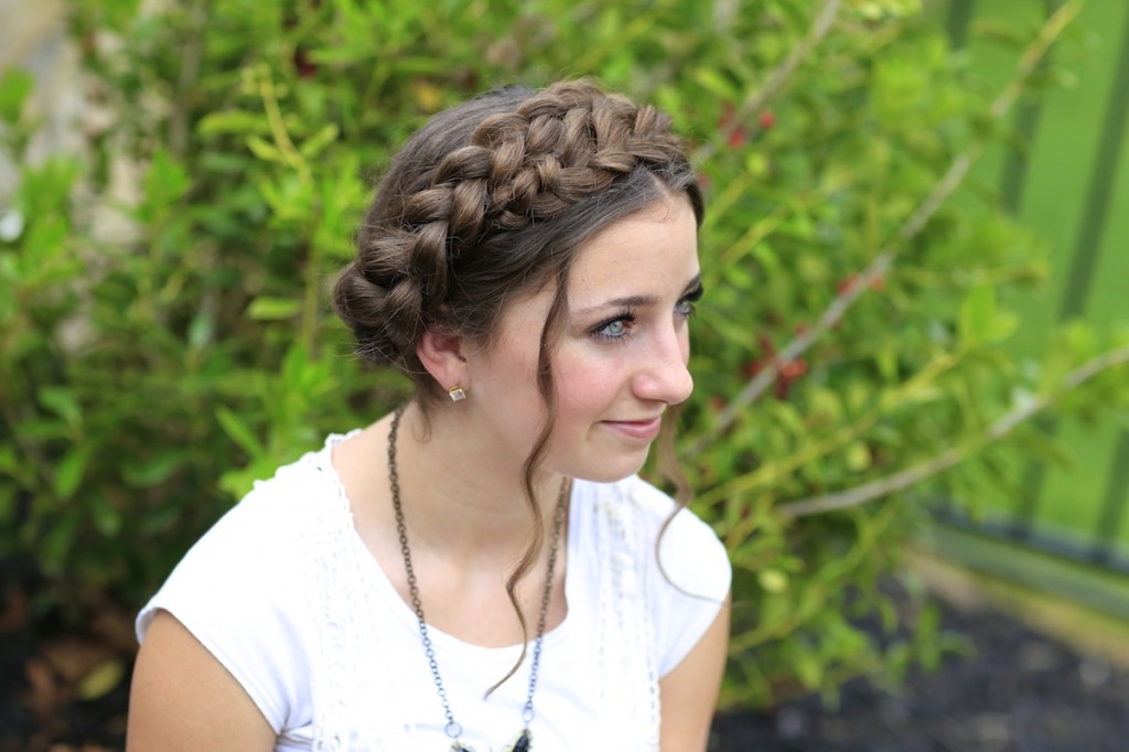 Young girl outside wearing a white shirt modeling Milkmaid Braids | Summer Hairstyles