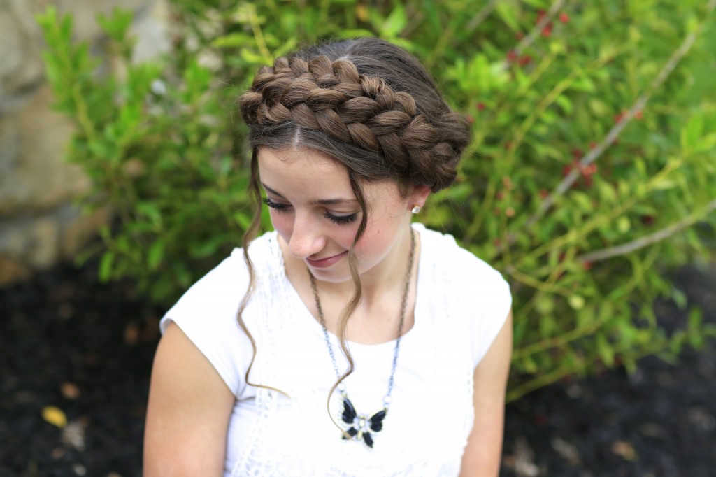 Young girl outside wearing a white shirt modeling Milkmaid Braids | Summer Hairstyles