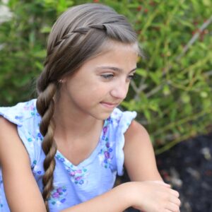 Little girl sitting outside modeling Waterfall Twist Into Rope Braid