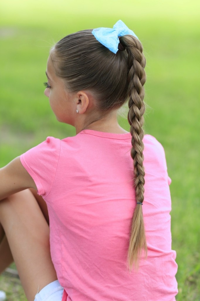 Little girl outside wearing a pink shirt modeling 3D Split Braid