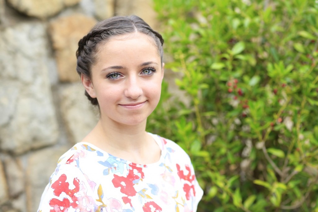 Portrait of young girl outside modeling Lace-Rolled Updo Hairstyle