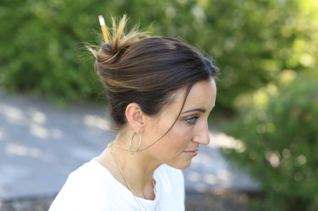 Profile of woman outside modeling Pencil Messy Buns | Back-to-School Hairstyles