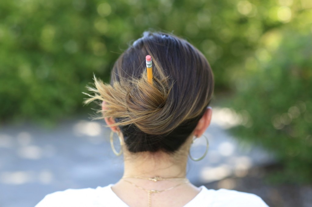 Woman outside modeling Pencil Messy Buns | Back-to-School Hairstyles (Back)