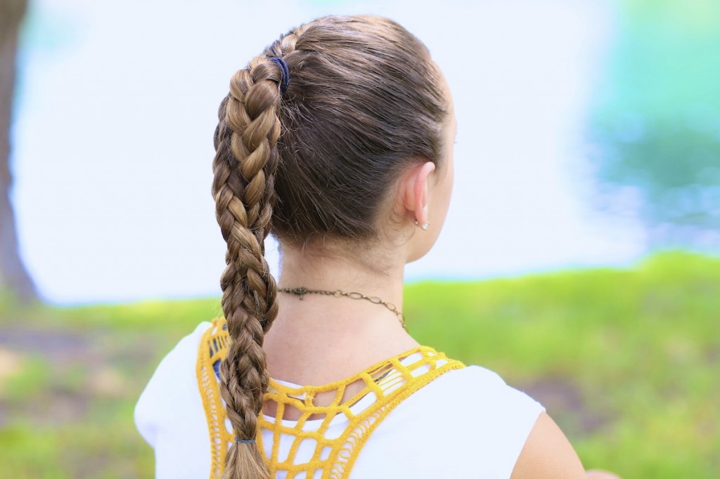 Young girl standing outside modeling The Run Braid Combo | Hairstyles for Sports