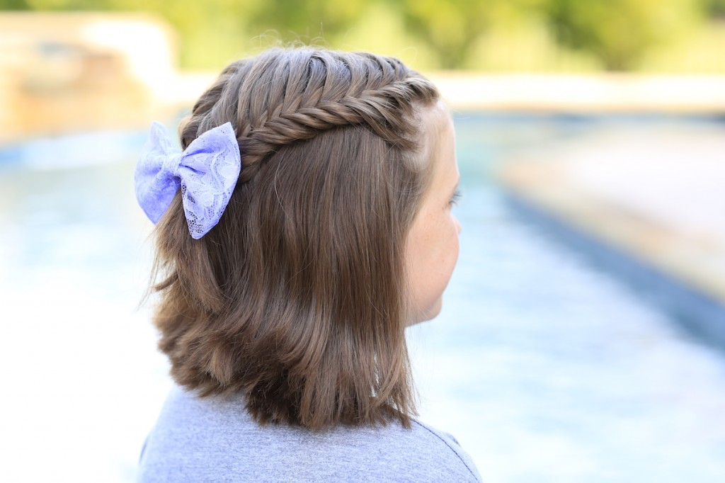 Little girl sitting by the pool modeling Laced Fishtail Tieback